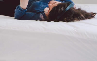 Woman lying on Micro Plush sheet on bed