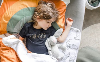 Young child sleep on bed pad